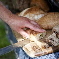Samples of bread are cut during the Cobblestone Farm Farmers Market on Tuesday, May 21. Daniel Brenner I AnnArbor.com